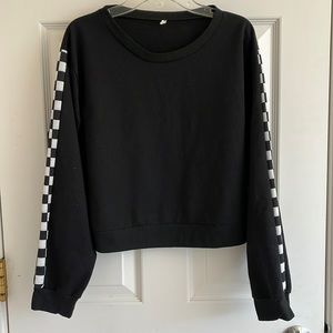 Cropped black sweater with checkered sleeves